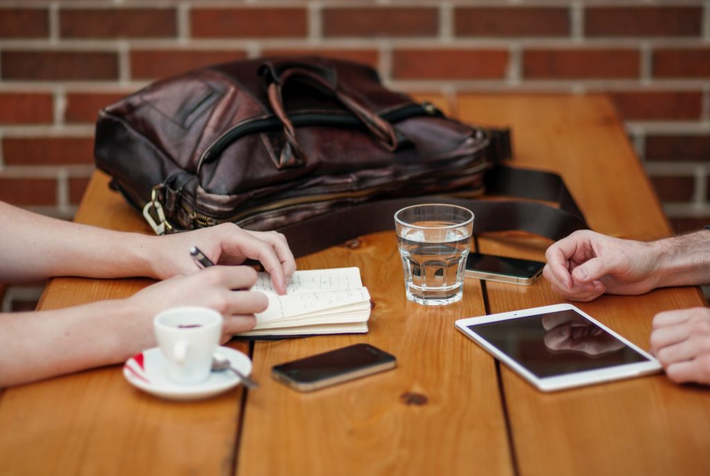 Manager and designated lead coaching over a coffee