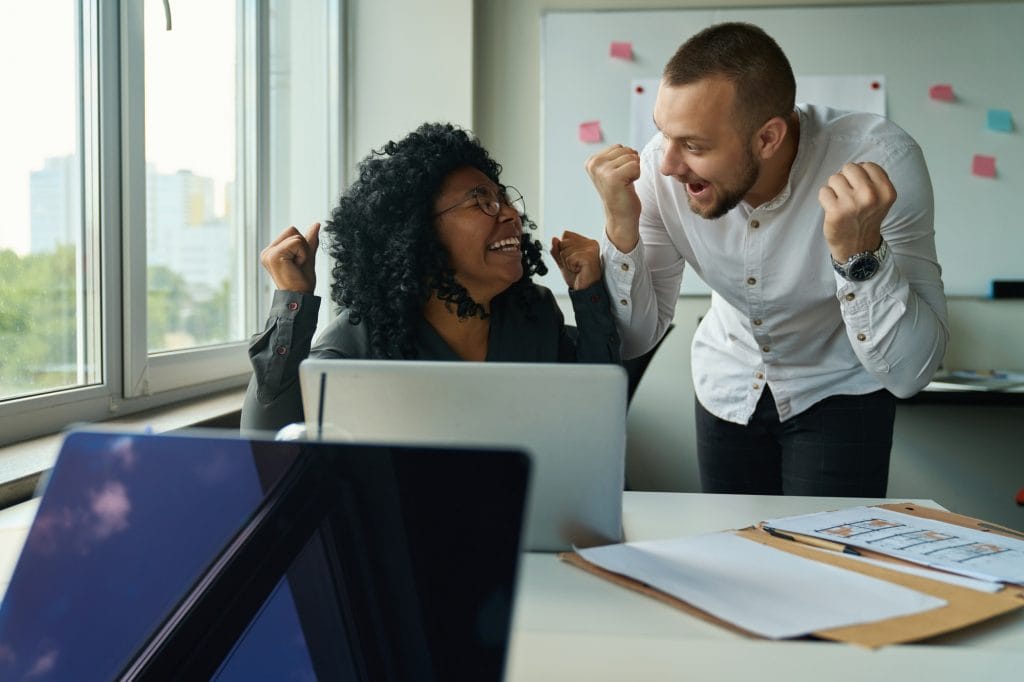 Managers at the computer rejoice at the promotion